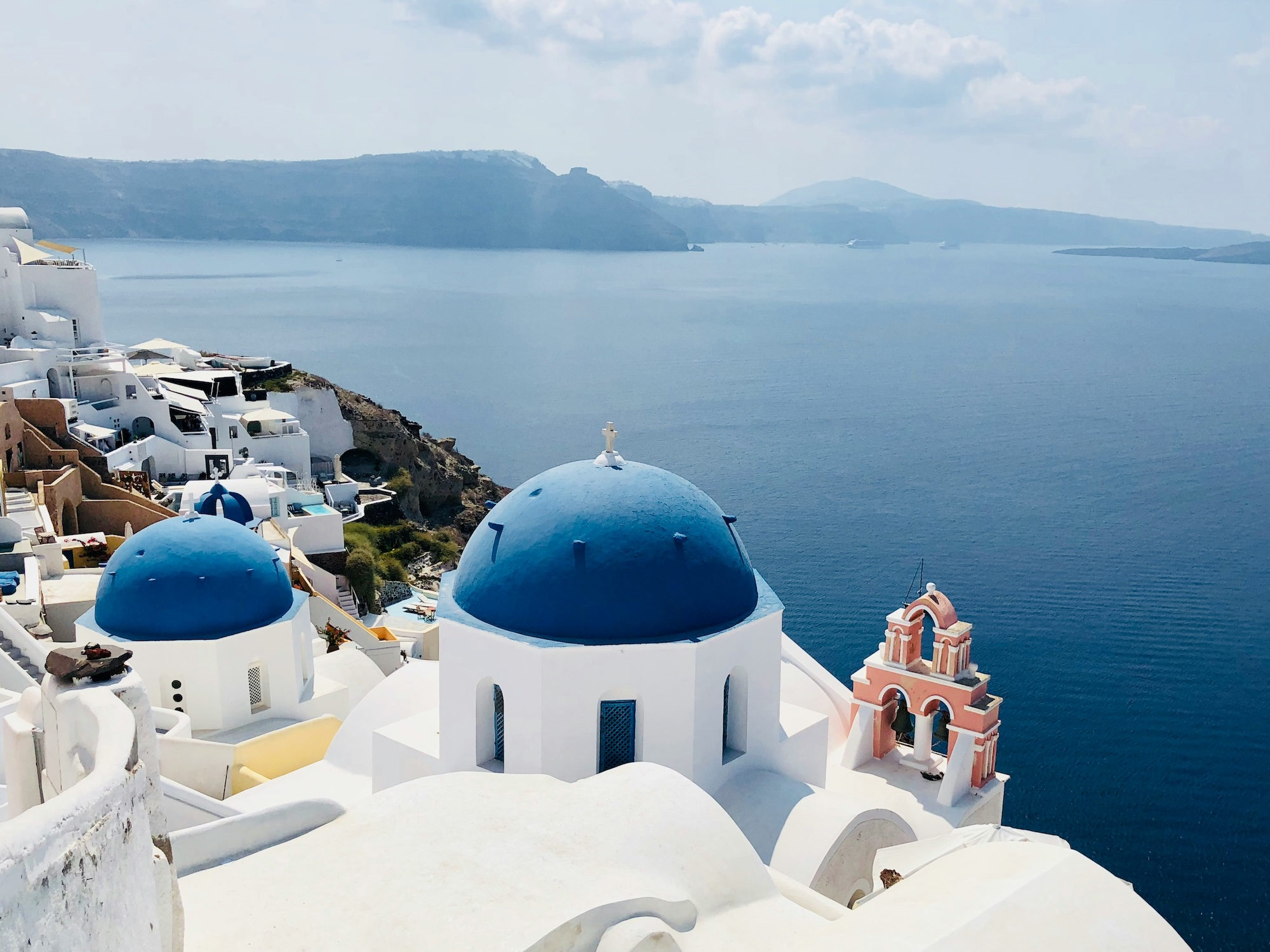 Blue church domes overlooking the sea in Oia, Santorini, Greece