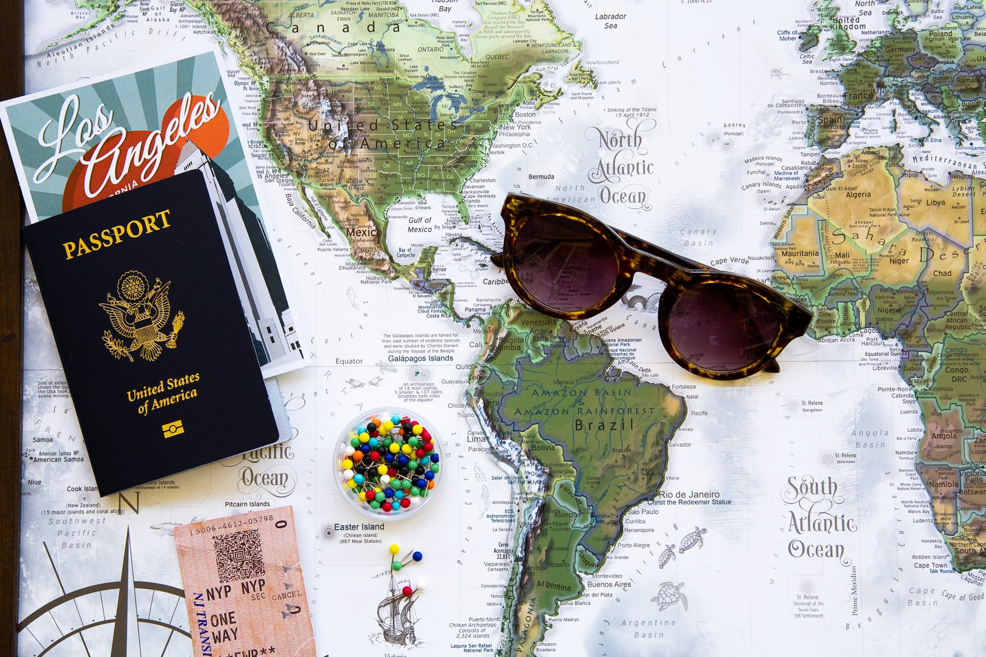 Brown framed sunglasses resting on a world map