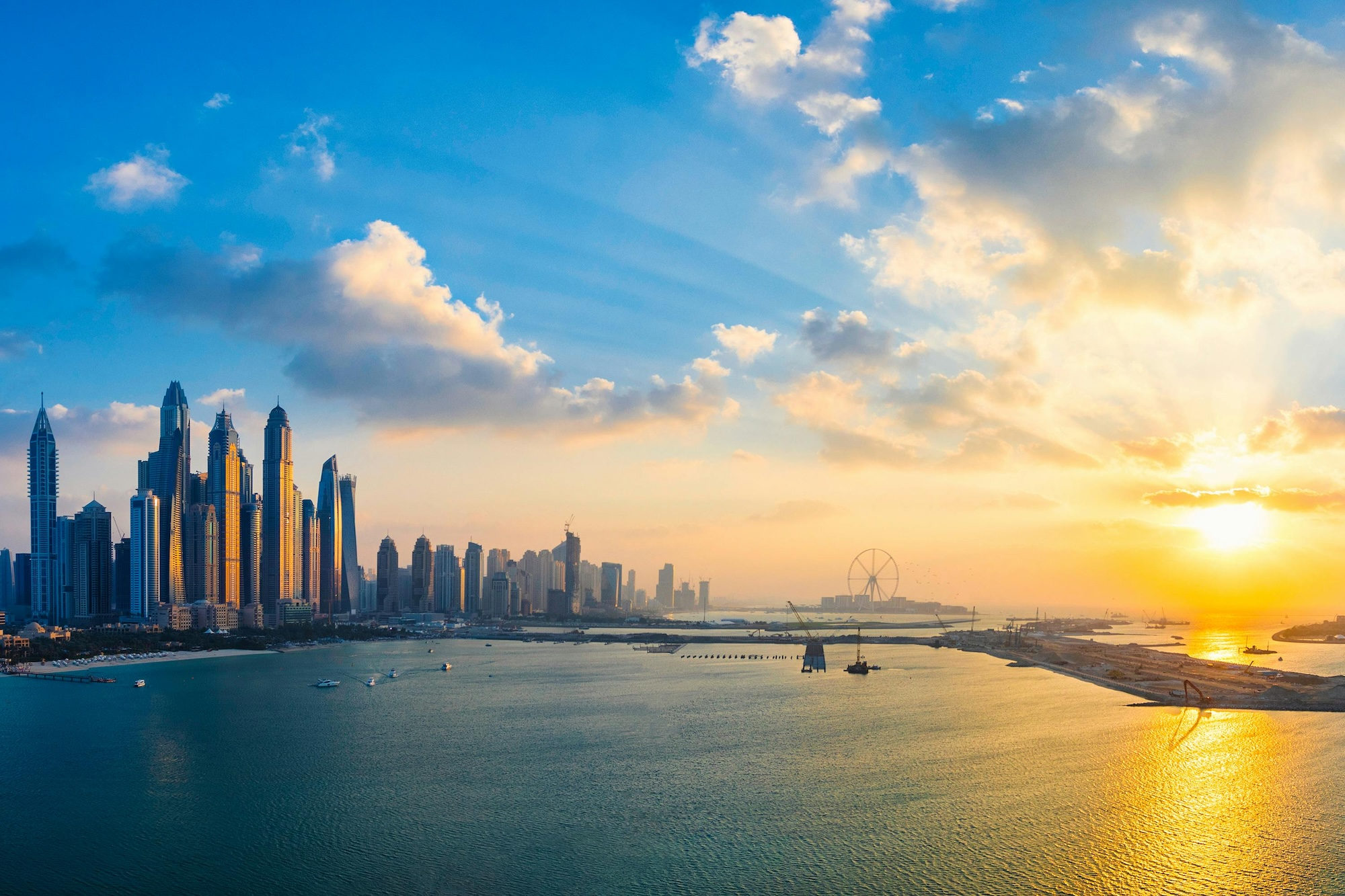 New York City skyline under blue sky and white clouds