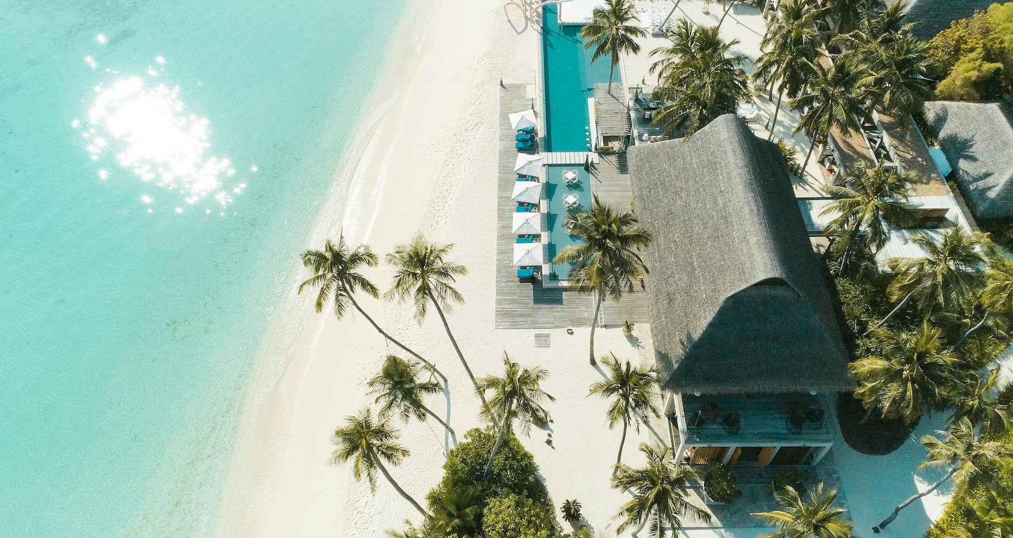 Aerial view of a beach resort with turquoise water and white sand