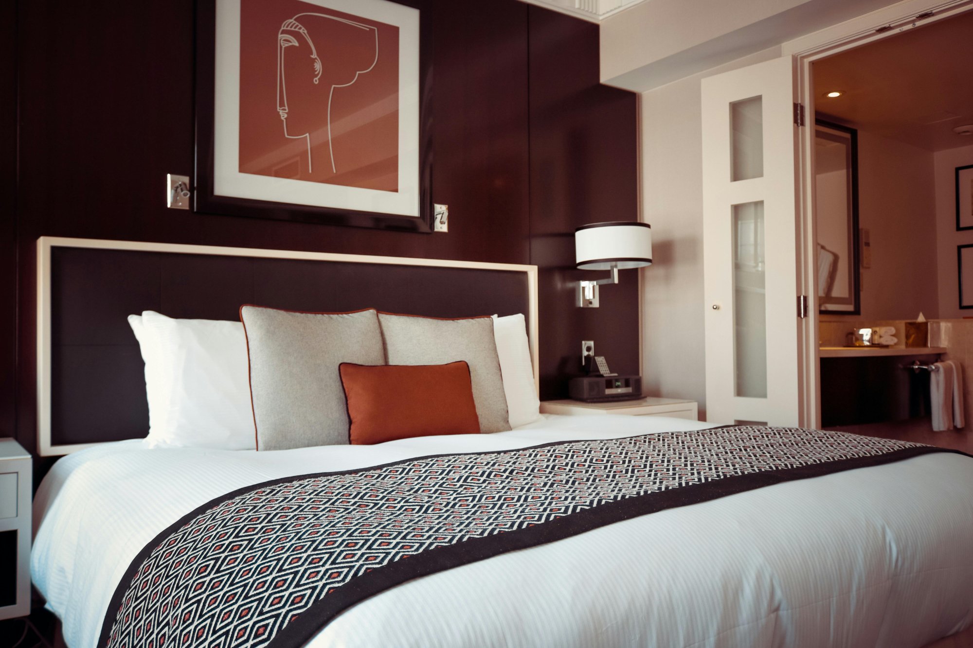 Elegant luxury hotel room with designer bedding and artwork