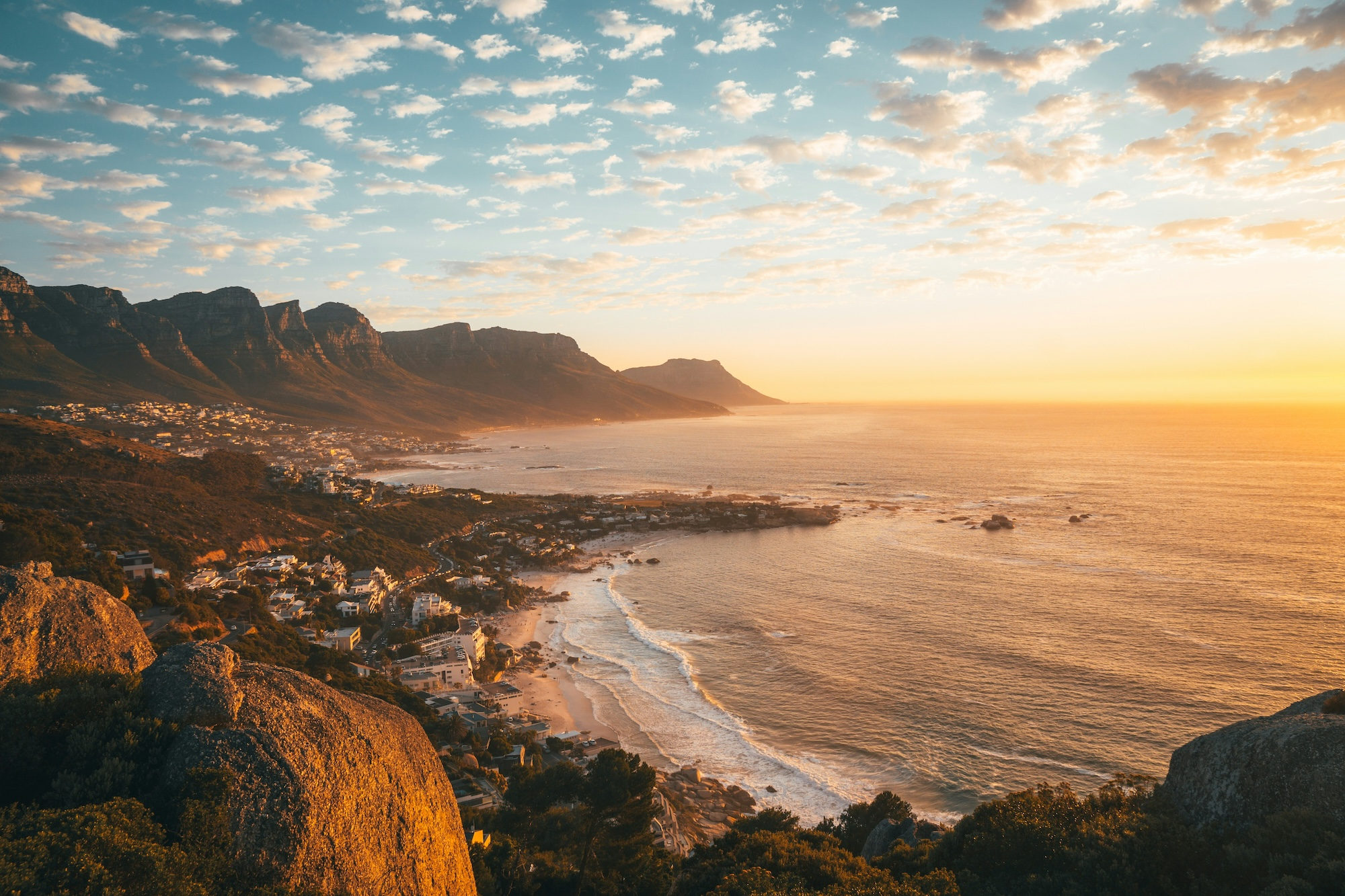 Scenic coastline with rocky mountains beside the sea at sunset